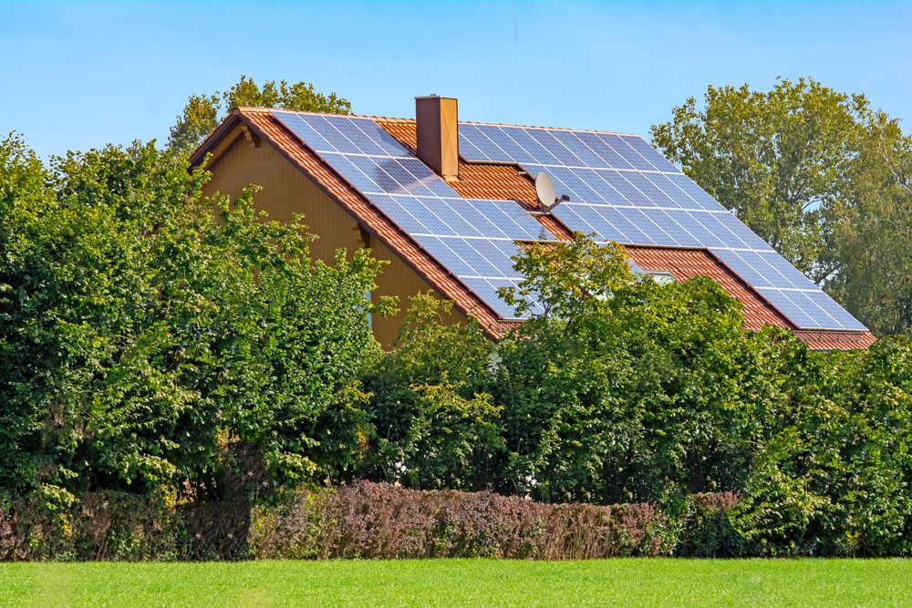 Modern house with photovoltaic solar cells on the roof for alternative energy production